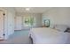 Light-filled bedroom with soft carpet, double doors, and view from the window, creates a peaceful atmosphere at 16256 N 64Th Pl, Scottsdale, AZ 85254