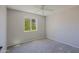 Bright bedroom with plush carpeting and a window view of lush greenery at 16256 N 64Th Pl, Scottsdale, AZ 85254