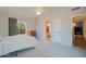Spacious bedroom with plush carpeting, ceiling fan, and ensuite bathroom for comfortable living at 16256 N 64Th Pl, Scottsdale, AZ 85254