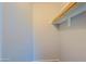 Closet interior with a single wooden rod for hanging clothes at 16256 N 64Th Pl, Scottsdale, AZ 85254