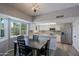 Spacious dining room with kitchen and views to the backyard from the bay window at 16256 N 64Th Pl, Scottsdale, AZ 85254