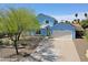 Two-story home with attached garage, long driveway, and desert landscaping at 16256 N 64Th Pl, Scottsdale, AZ 85254