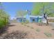 Two-story home featuring a light blue exterior, desert landscaping, and a gravel yard at 16256 N 64Th Pl, Scottsdale, AZ 85254