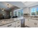 Updated kitchen with granite counters, modern appliances, island and adjacent living area at 16256 N 64Th Pl, Scottsdale, AZ 85254
