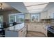 Updated kitchen with white cabinets, granite counters, modern appliances and bay window looking to the backyard at 16256 N 64Th Pl, Scottsdale, AZ 85254