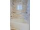Marble tiled shower and tub with a rainfall showerhead, creates a spa-like retreat at 16256 N 64Th Pl, Scottsdale, AZ 85254
