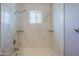 Elegant shower with marble walls, built-in shelves and designer window at 16256 N 64Th Pl, Scottsdale, AZ 85254