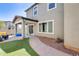 Backyard featuring a patio, artificial turf, and a walkway leading to a covered patio at 16562 W Sierra St, Surprise, AZ 85388