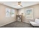 Comfortable bedroom featuring neutral walls, a ceiling fan, and natural light from two windows at 16562 W Sierra St, Surprise, AZ 85388