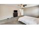 Carpeted bedroom featuring ceiling fan, with a TV above dark dresser, ideal for unwinding at 16562 W Sierra St, Surprise, AZ 85388