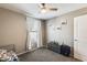 Neutral-toned bedroom featuring a ceiling fan, a window, and a dresser for storage at 16562 W Sierra St, Surprise, AZ 85388