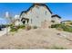 Two-story home with a landscaped front yard and a covered front porch with stone accents at 16562 W Sierra St, Surprise, AZ 85388