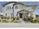 Charming two-story home with a landscaped yard and a covered front entrance with stone accents at 16562 W Sierra St, Surprise, AZ 85388