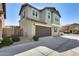 Charming two-story home features a brown garage door, desert landscaping, and multiple windows at 16562 W Sierra St, Surprise, AZ 85388