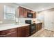 Well-lit kitchen featuring wood cabinets, laminate counters, and modern appliances at 16562 W Sierra St, Surprise, AZ 85388