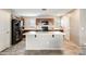 Well-lit kitchen with an island, modern appliances, and wooden cabinets and black refrigerator at 16562 W Sierra St, Surprise, AZ 85388
