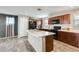 Well-equipped kitchen with dark cabinets, island, and black appliances at 16562 W Sierra St, Surprise, AZ 85388