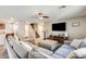 Spacious living room featuring a large sectional sofa, ceiling fan, and a flat-screen TV at 16562 W Sierra St, Surprise, AZ 85388