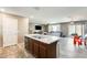 Open floorplan with seamless transition from kitchen to living area, great for Gathering gatherings at 16562 W Sierra St, Surprise, AZ 85388
