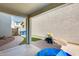 Covered patio with a hardscape and an adjacent artificial grass area at 16562 W Sierra St, Surprise, AZ 85388