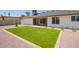 Beautiful backyard with a green lawn area, low maintenance landscaping, and a covered patio at 17411 N 36Th St, Phoenix, AZ 85032
