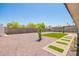 Expansive backyard featuring low-maintenance landscaping, gravel, and a charming stepping stone path at 17411 N 36Th St, Phoenix, AZ 85032