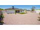 Spacious backyard offering low-maintenance gravel landscaping and a cozy green lawn at 17411 N 36Th St, Phoenix, AZ 85032