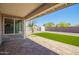 Covered patio and backyard with artificial grass and desert landscaping at 17411 N 36Th St, Phoenix, AZ 85032
