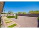 Large backyard featuring low-maintenance landscaping, artificial turf, and a stepping stone path at 17411 N 36Th St, Phoenix, AZ 85032
