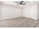 Spacious bedroom boasts new light gray flooring, ceiling fan, and double door closet space at 17411 N 36Th St, Phoenix, AZ 85032