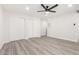 Bright bedroom features light grey flooring, ceiling fan, and closet with view to adjacent room at 17411 N 36Th St, Phoenix, AZ 85032