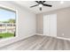 This bedroom features light grey flooring and a view of a well manicured front yard through a window at 17411 N 36Th St, Phoenix, AZ 85032