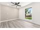Neutral bedroom features a view to the outdoors and wood-look flooring at 17411 N 36Th St, Phoenix, AZ 85032