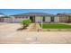 Attractive single-story house with a meticulously landscaped front yard featuring desert plants and a green artificial lawn at 17411 N 36Th St, Phoenix, AZ 85032