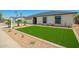 Charming single-story home with a well-maintained front yard featuring artificial grass and desert landscaping at 17411 N 36Th St, Phoenix, AZ 85032