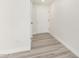 Hallway shows light gray floors with white walls and baseboards that leads to a white front door at 17411 N 36Th St, Phoenix, AZ 85032