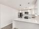 The modern kitchen boasts white cabinetry, stainless steel appliances, and a functional breakfast bar for casual dining at 17411 N 36Th St, Phoenix, AZ 85032