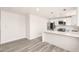 Open floor plan shows modern kitchen with quartz countertops and stainless appliances in the living area at 17411 N 36Th St, Phoenix, AZ 85032