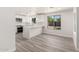 Bright, all-white kitchen featuring modern appliances, quartz countertops, and an open layout to the living area at 17411 N 36Th St, Phoenix, AZ 85032