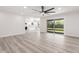 Open concept living room with modern floors, white walls, and view into the kitchen at 17411 N 36Th St, Phoenix, AZ 85032