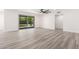 Spacious living room featuring neutral-colored walls, modern flooring, and sliding glass doors leading to the backyard at 17411 N 36Th St, Phoenix, AZ 85032