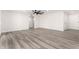 Bright living room with new flooring, ceiling fan, and white walls providing a clean and modern aesthetic at 17411 N 36Th St, Phoenix, AZ 85032
