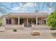 Outdoor living in this backyard features a covered patio, desert landscape, and backyard BBQ at 18013 N Sterling Dr, Surprise, AZ 85374