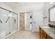 This primary bathroom features double vanity with a large glass shower and tile flooring at 18013 N Sterling Dr, Surprise, AZ 85374