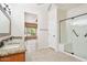 Bathroom featuring double sinks, granite countertops, tiled floors and a glass enclosed shower at 18013 N Sterling Dr, Surprise, AZ 85374