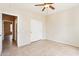Clean bedroom with neutral walls, ceiling fan and tile floors leading out to the hallway at 18013 N Sterling Dr, Surprise, AZ 85374