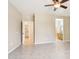 Neutral bedroom with tile floors, ceiling fan, and bathroom and closet access at 18013 N Sterling Dr, Surprise, AZ 85374
