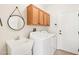 Well organized laundry room with oak cabinets, a sink, and a washer and dryer at 18013 N Sterling Dr, Surprise, AZ 85374