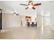 Expansive living room with tile floors, ceiling fans, and an open floor plan connecting to the kitchen at 18013 N Sterling Dr, Surprise, AZ 85374