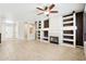 Spacious living area featuring a fireplace, built-in shelving, and tile flooring, perfect for entertaining at 18013 N Sterling Dr, Surprise, AZ 85374